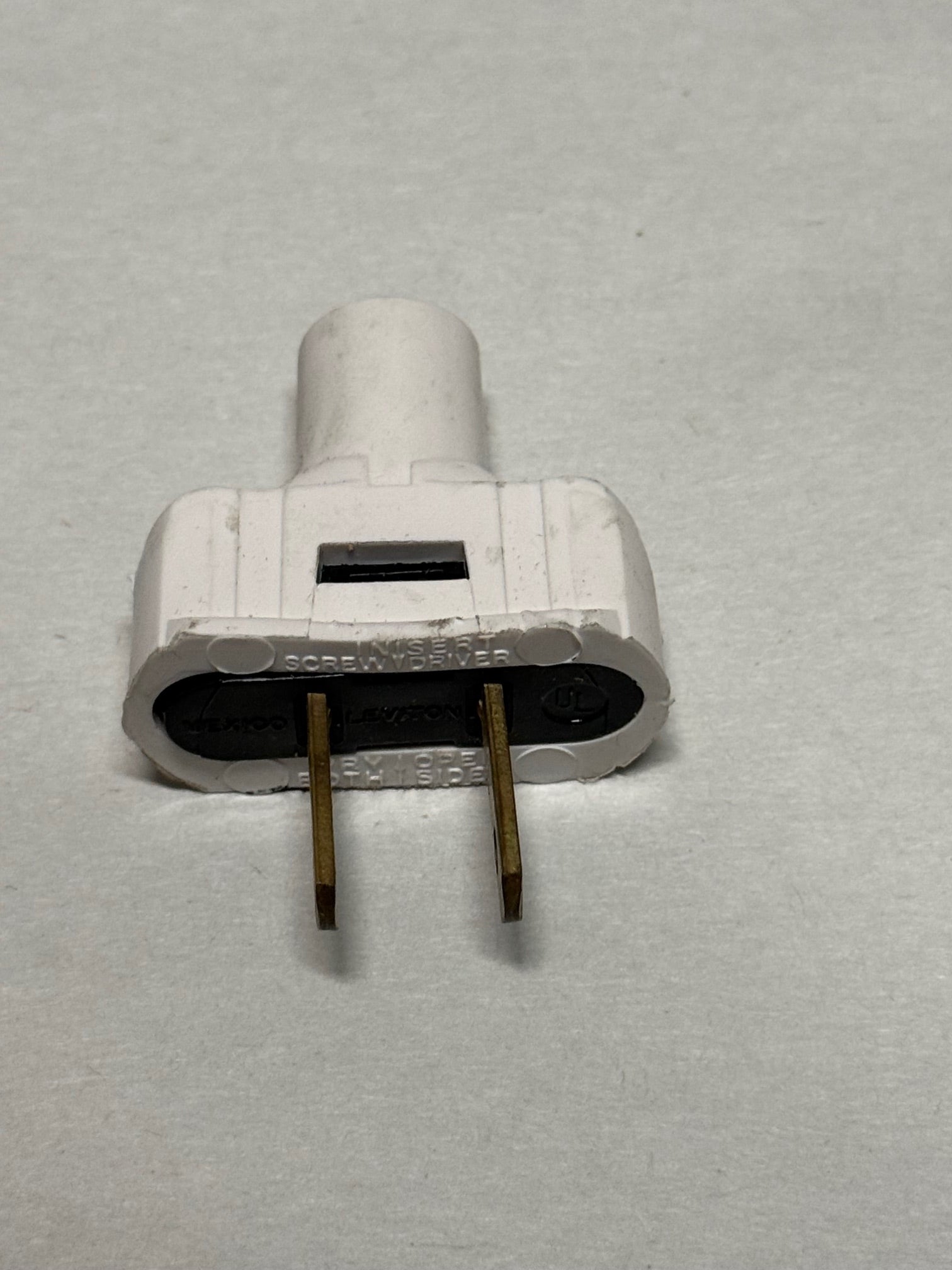White Leviton 2-Pole, 2-Wire Flat Plug, 15A - 126V, UL Listed.