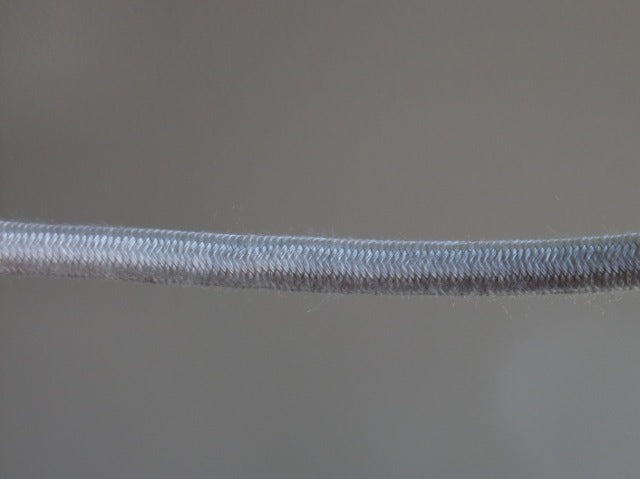 Stranded copper conductor, separator, rubber insulation, cotton braid, conductors twisted, cotton braid all over.